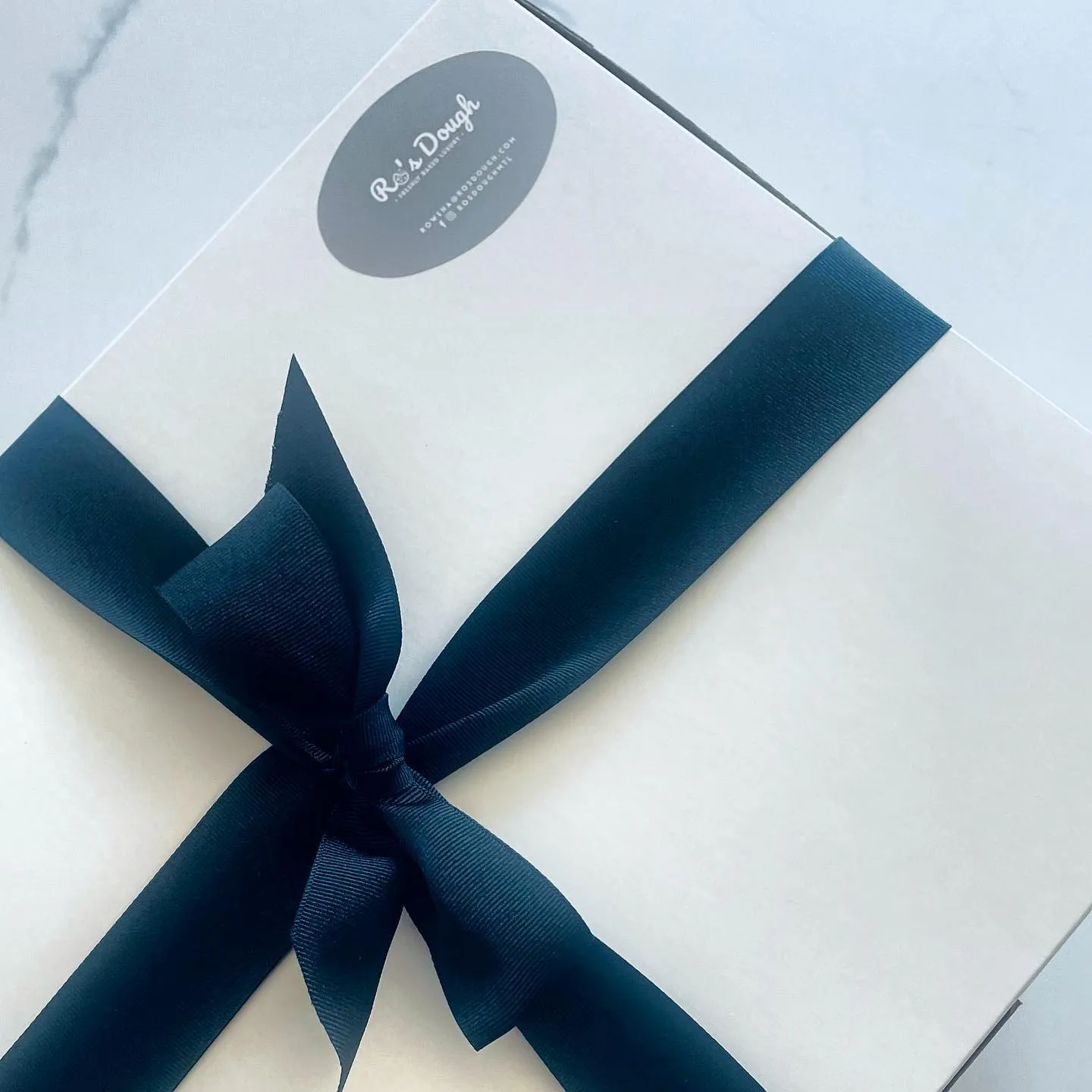 Closed box navy ribbon gift detail