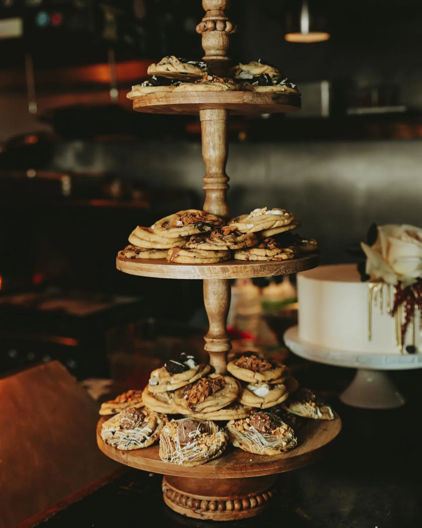 Cookies stacked on a tiered wooden stand at an event