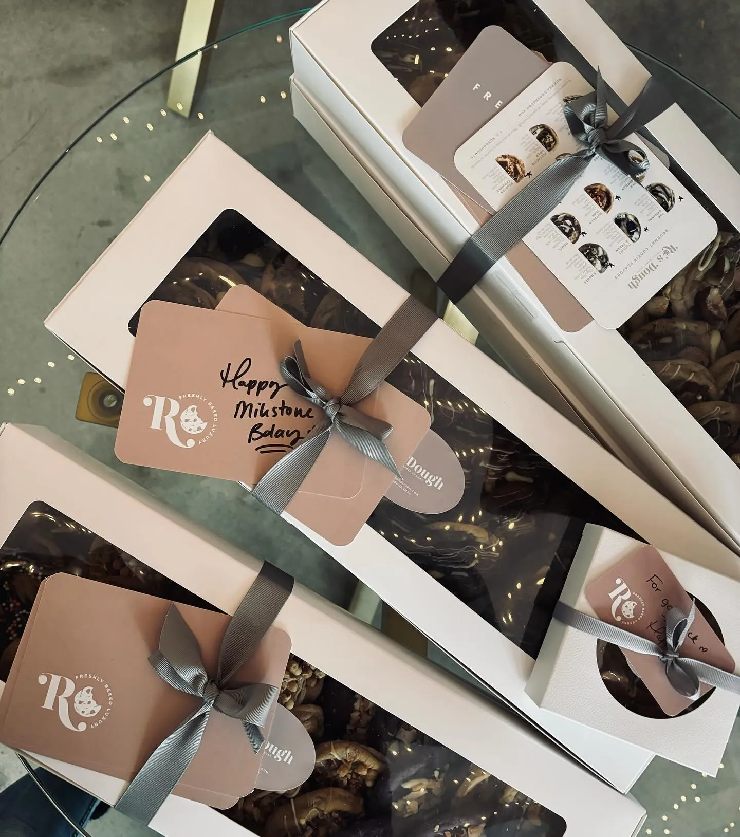 Handwritten note cards laid beside boxed cookies